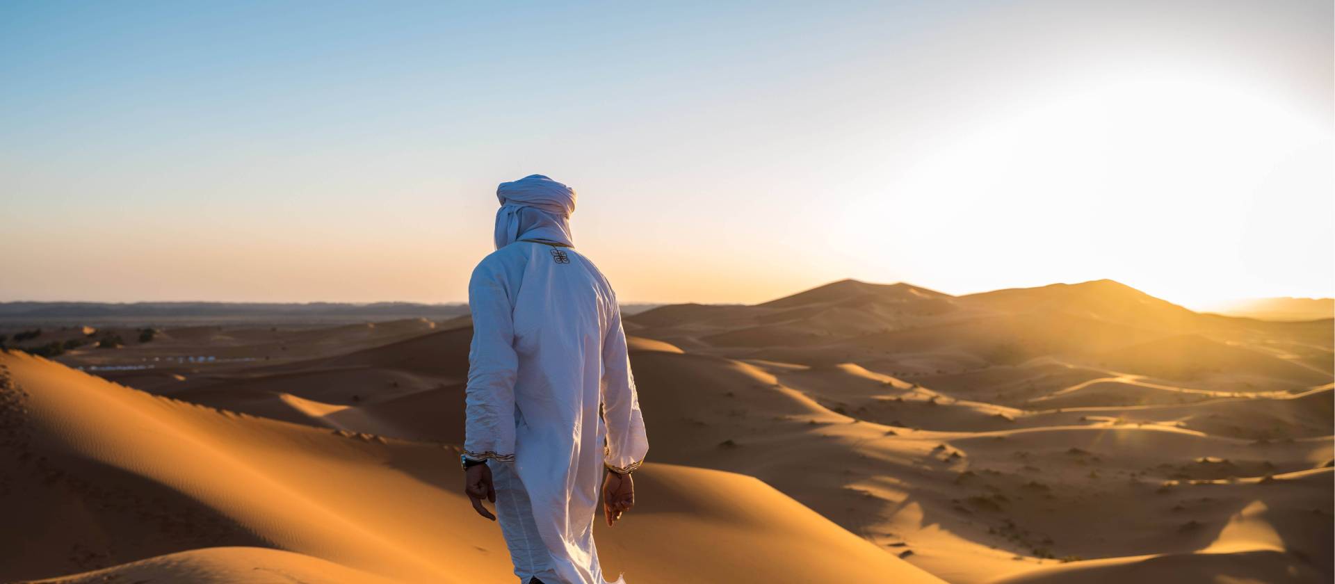 A local man walks atop sand dunes in the Sahara, Morocco | James Griesedieck
