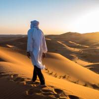 A local man walks atop sand dunes in the Sahara, Morocco | James Griesedieck