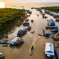 The sun setting over Mechrey floating village, Cambodia | Lachlan Gardiner