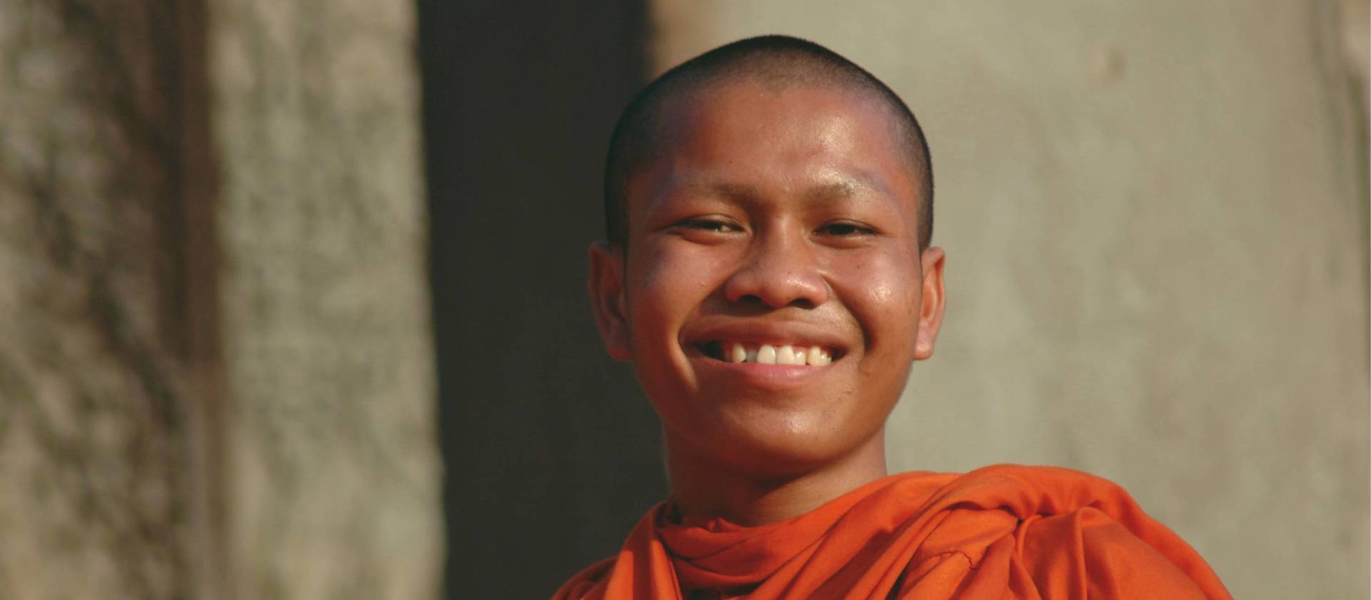 On all our journeys to Cambodia we visit the ruins of Angkor Wat where saffron robed monks greet us with warm smiles. | Donna Lawrence