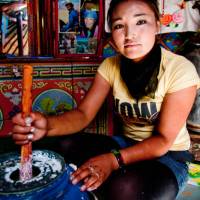 A local girl prepares food, Mongolia | Cam Cope