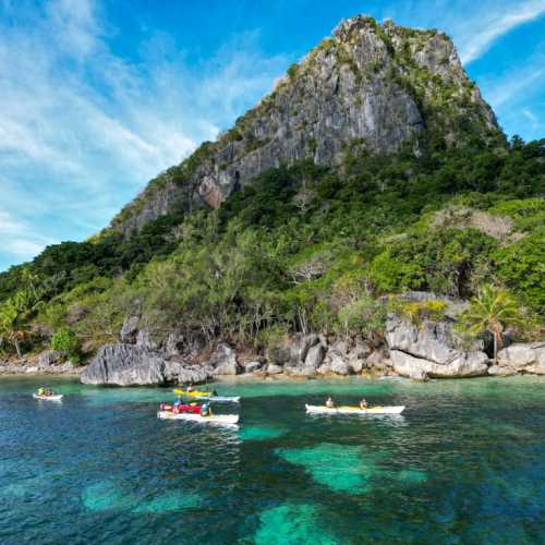 Kayaking group paddling the remote tropical waters of the Yasawa Islands