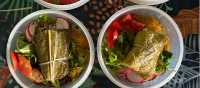 Locally prepared trail meals featuring traditional leaf-wrapped dishes