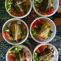 Locally prepared trail meals featuring traditional leaf-wrapped dishes