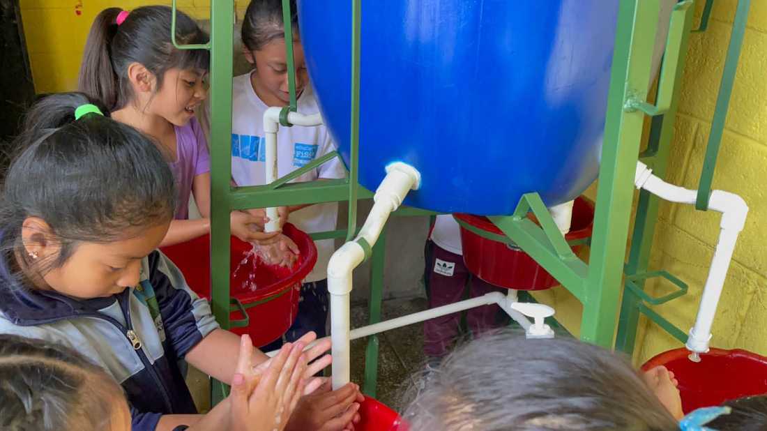Local school children using WASH sanitation hand washing system in Guatemalan water project | Los Buenos Vencinos NGO Guatemala