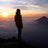 Hiker admiring the view from the summit of Volcan Acatenango