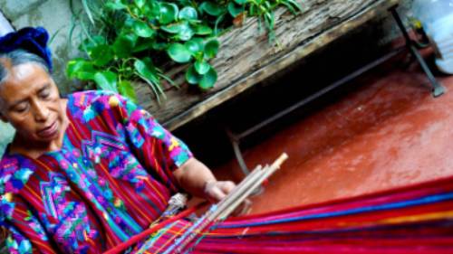 Learning the art of weaving under the guidance of a skilled local artisan