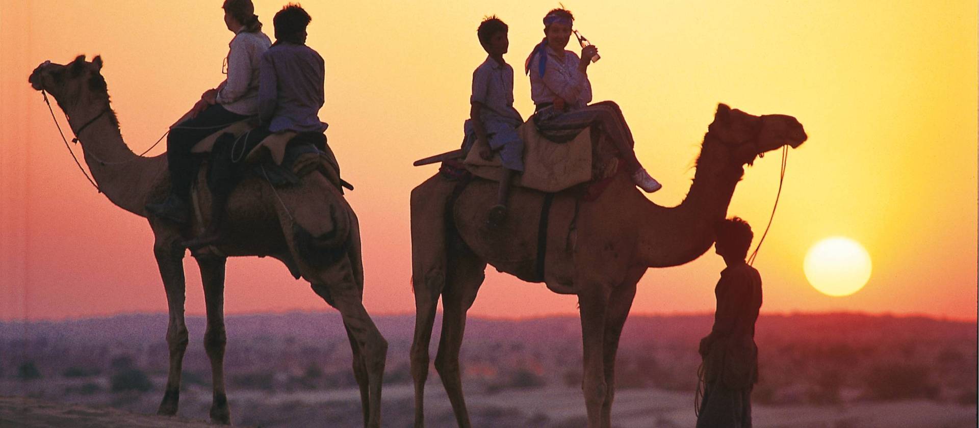 Camel riding at sunset, India | Andrew Thomasson