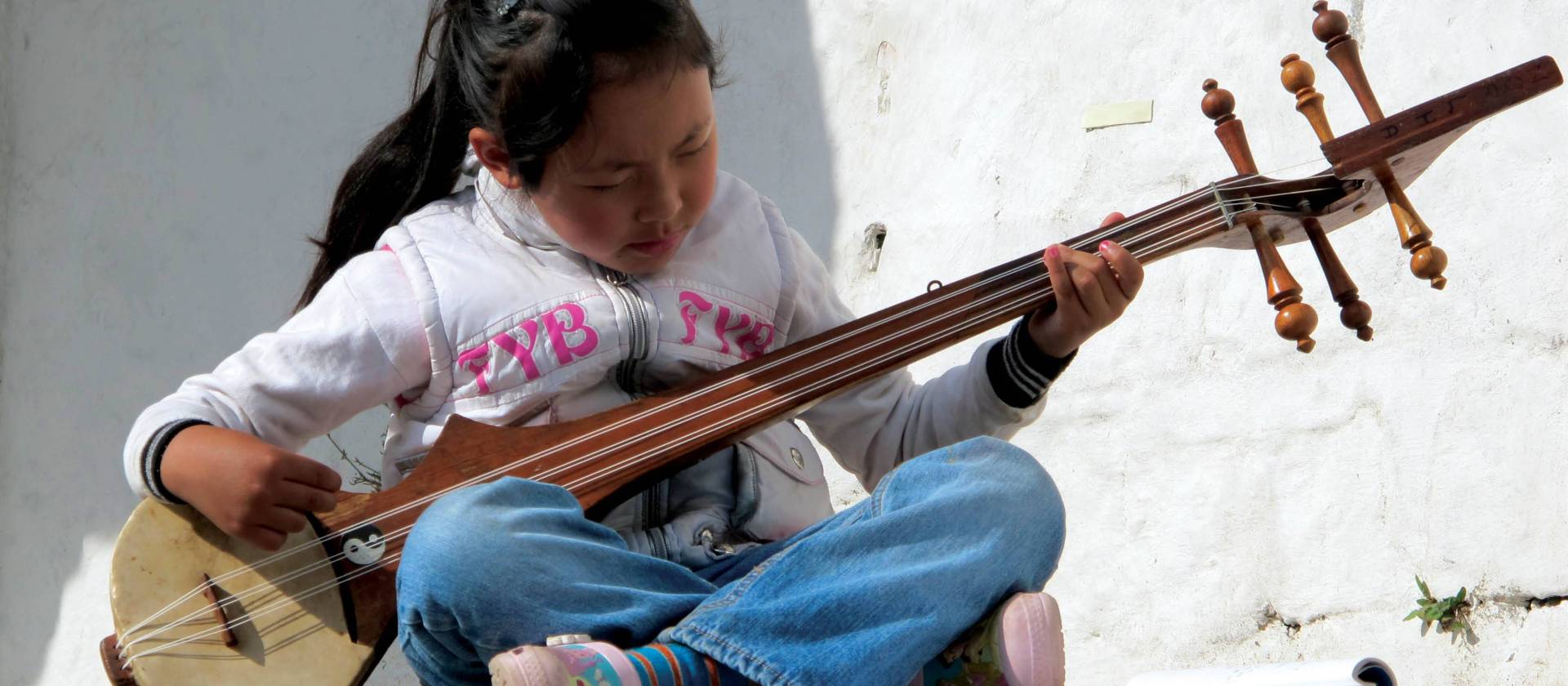 Cute local girl playing a traditional Indian instrument | Fiona Windon