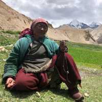 Markha valley villager tending her field with Kangyaze (6400m) in the background | Brad Atwal