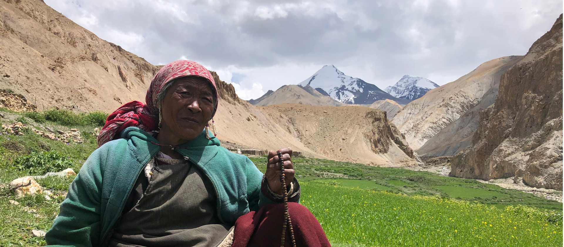Markha valley villager tending her field with Kangyaze (6400m) in the background | Brad Atwal