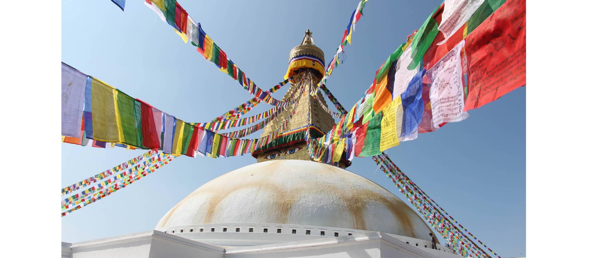 Prayer flags hang from the Boudhanath stupa in Kathmandu | Ayla Rowe