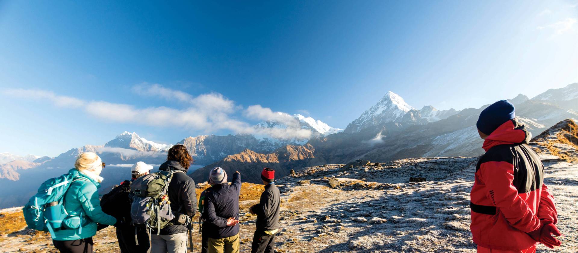 A World Expeditions porter looks on as the group enjoys the view on Kopra Ridge | Joe Kennedy