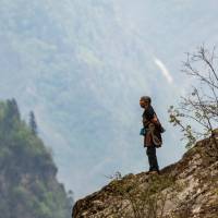 A local woman takes in the view of her part of the Himalaya | Lachlan Gardiner