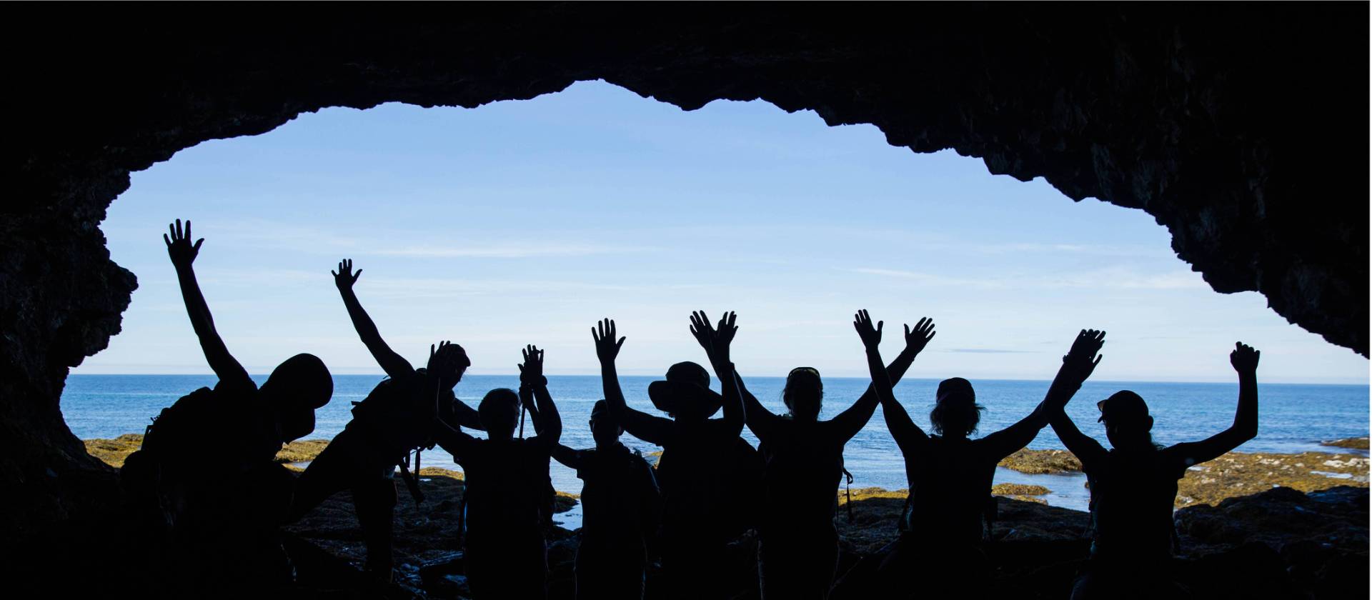 Students exploring the shore of Gros Morne