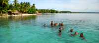 Children enjoying a swim in the waters of Melanesia | A Russ