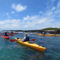 Sea kayaking through the pristine waters of Divine Bay in Galapagos.