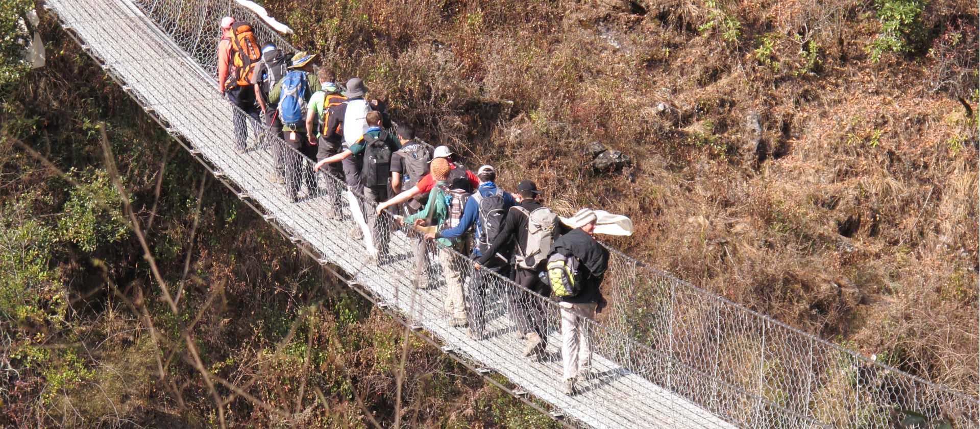 Students cross a bridge in the Everest region of Nepal | Greg Pike