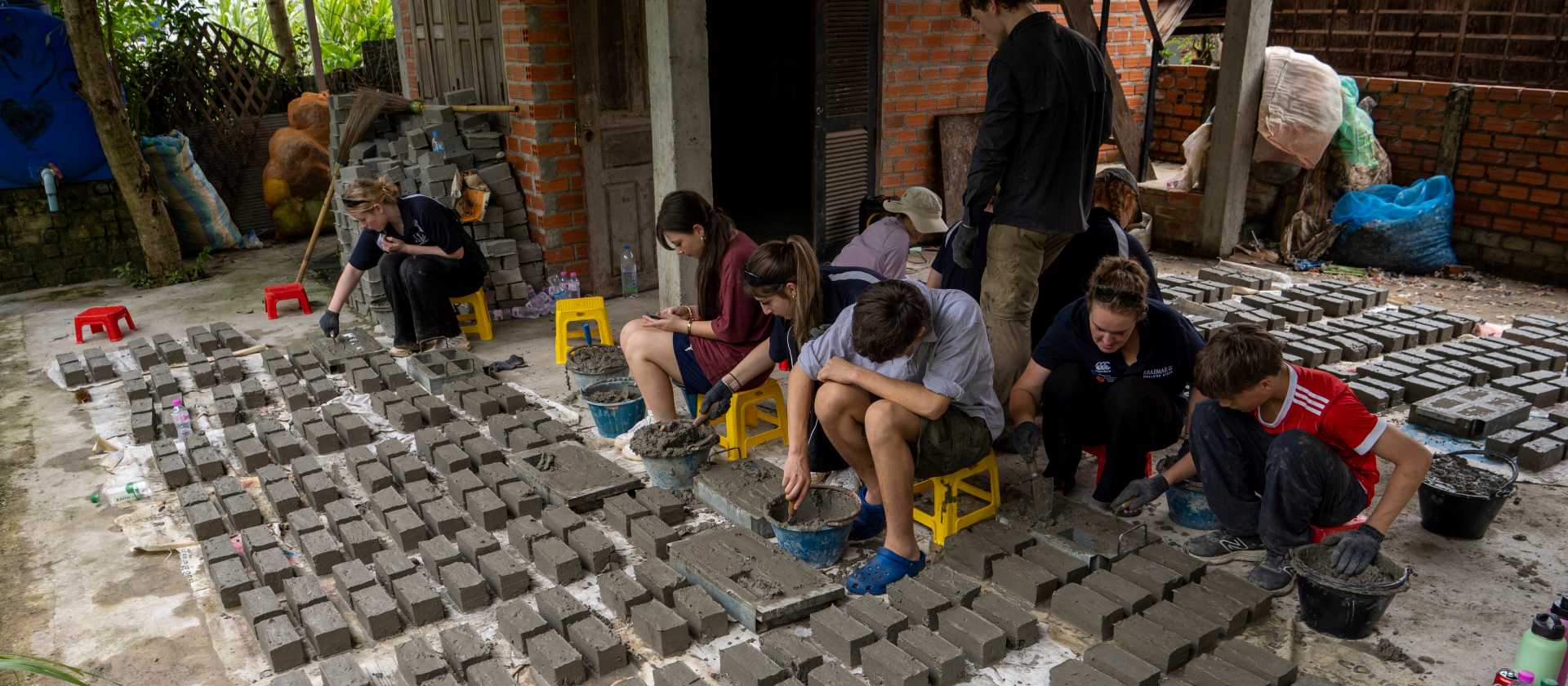 Students create bricks from plastic, and help build, during a service learning program | Jordan Curzon