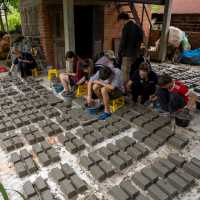 Students create bricks from plastic, and help build, during a service learning program | Jordan Curzon