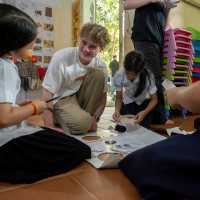 Students on a service learning program in Cambodia interacting with local students | Jordan Curzon