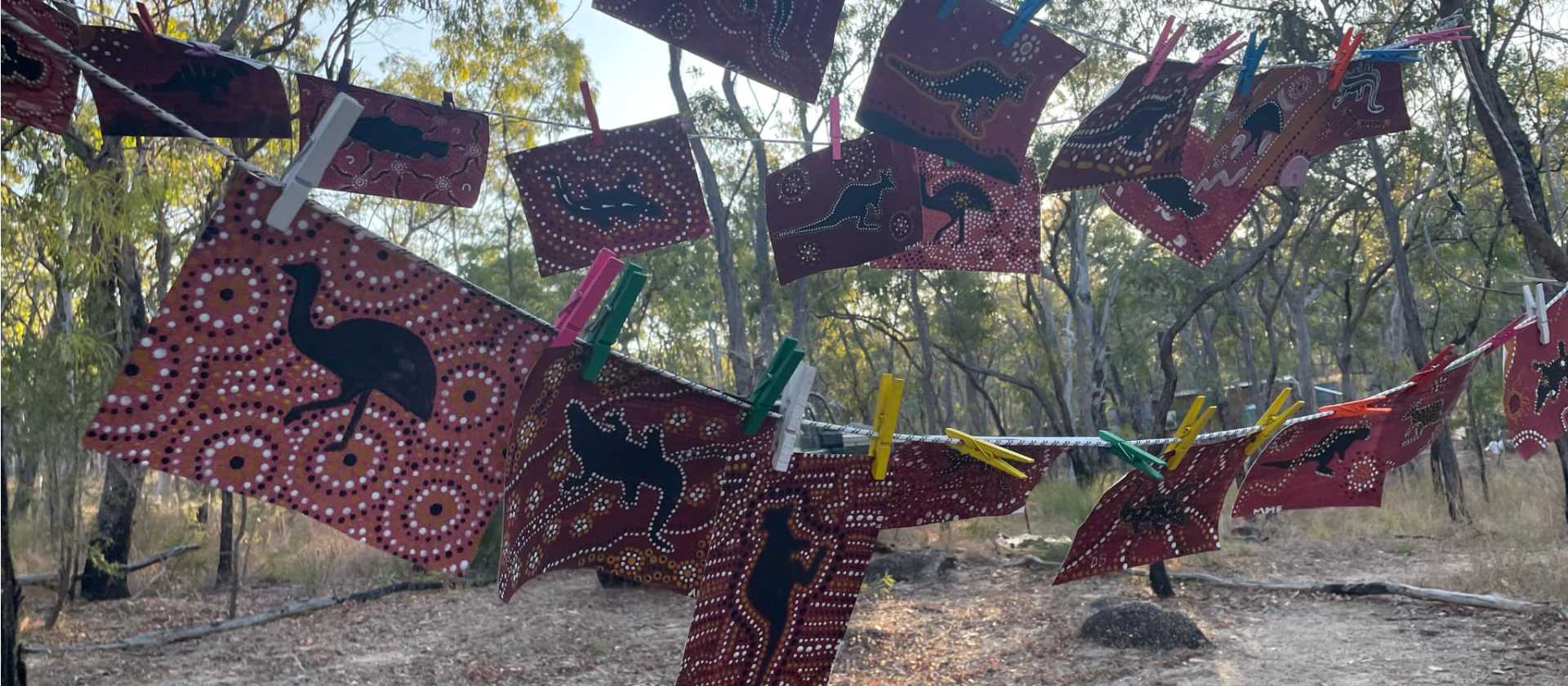 Student dot paintings drying on line