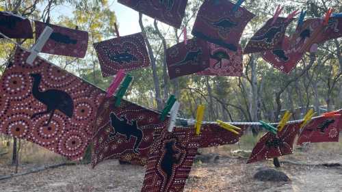 Student dot paintings drying on line