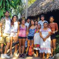 Happy faces come together after sharing time with the local community | EcoColours Tours