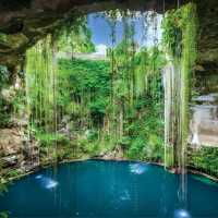 The clear turquoise waters of a cenote under a sunny sky | EcoColours Tours