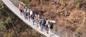 Students cross a bridge in the Everest region of Nepal | Greg Pike