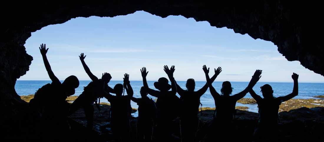 Students exploring the shore of Gros Morne